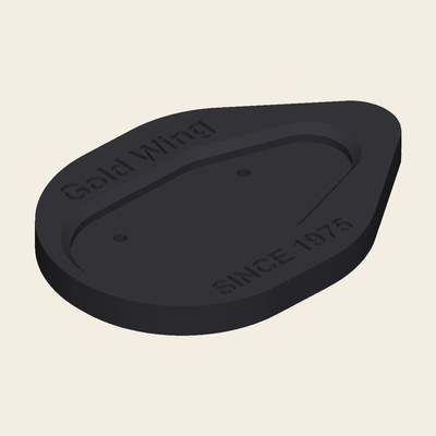A teardrop-shaped 3D-printed Honda Gold Wing side-stand pad with a tapered recessed foot cradle, Gold Wing and SINCE 1975 etched on top, and a grab tab