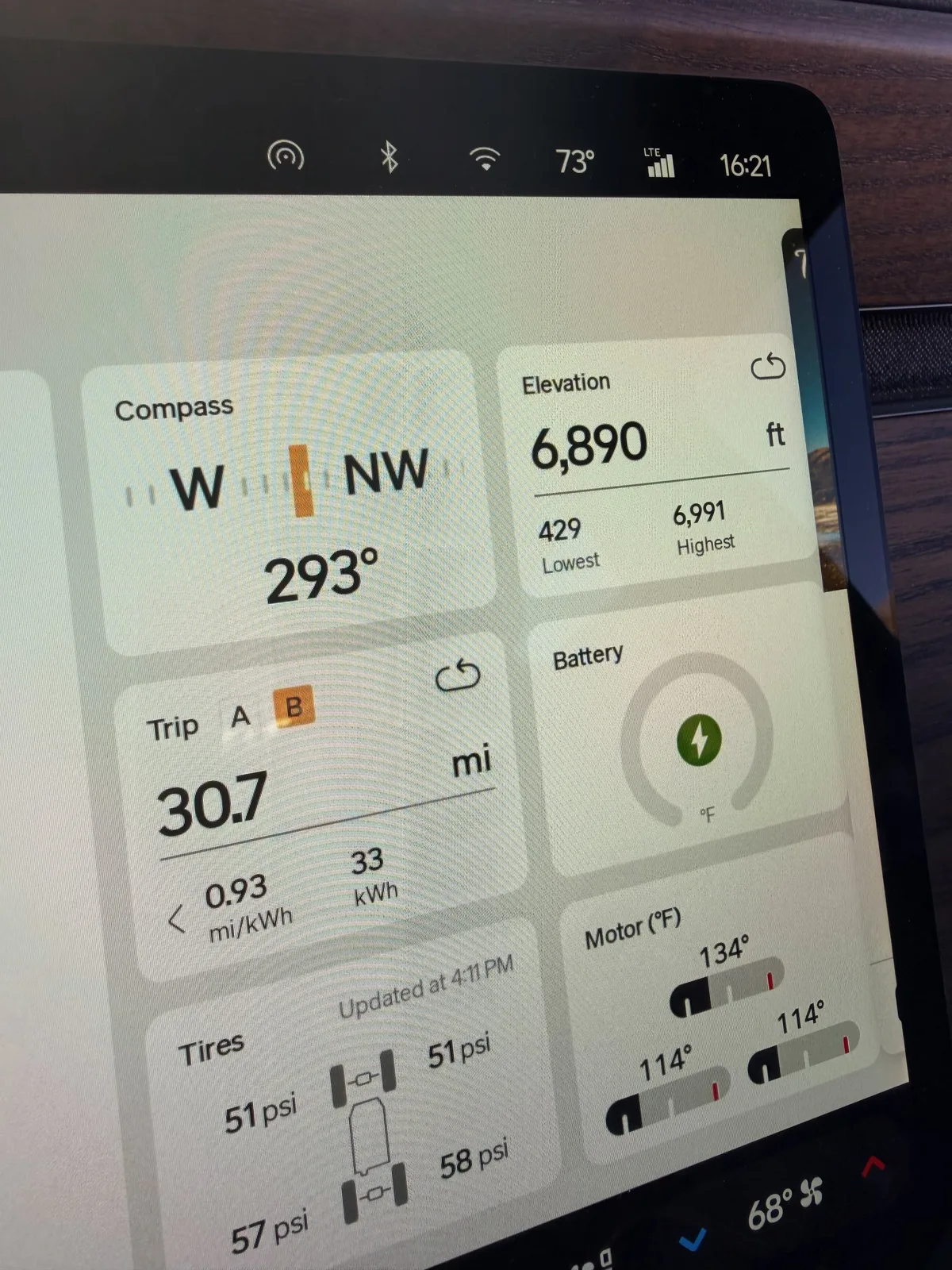 The Rivian R1T center display at the Flagstaff RAN showing Trip B 30.7 miles at 0.93 mi/kWh, 33 kWh used, elevation 6,890 ft (lowest 429, highest 6,991), compass 293 degrees west-northwest, motor temps 114 to 134°F, ambient 73°F