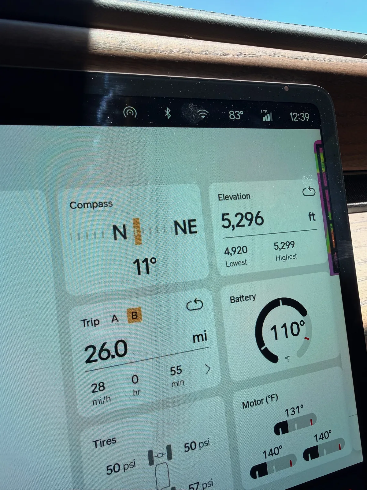 The Rivian R1T center display back at the Uptown RAN at 12:39 PM after the Twisters loop, Trip B 26.0 miles at 28 mph over 55 minutes, battery 110°F, motor temps 131 to 140°F, tires 50 to 57 psi, ambient 83°F, elevation 5,296 ft
