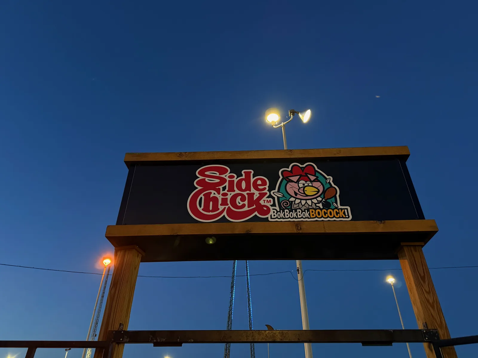The large illuminated Bigfoot Fun Park sign on the Branson strip at dusk, a stylized Sasquatch on a tall lit structure