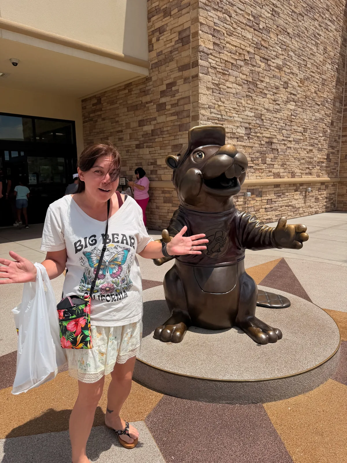 Diana posing with arms out beside a large Bigfoot statue at the Bigfoot Fun Park in Branson
