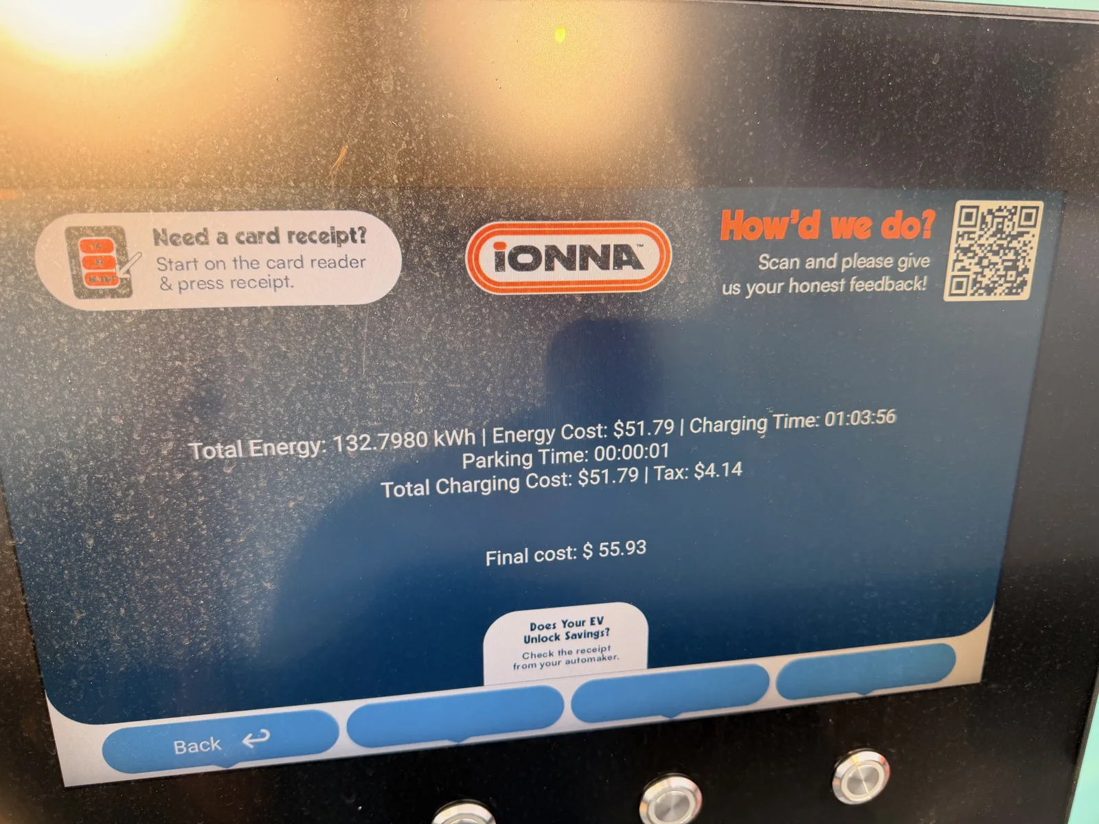 The IONNA Rechargery charger display showing the McHenry session receipt, 132.7980 kWh delivered for $55.93 total at $0.39 per kWh, the big evening top-off