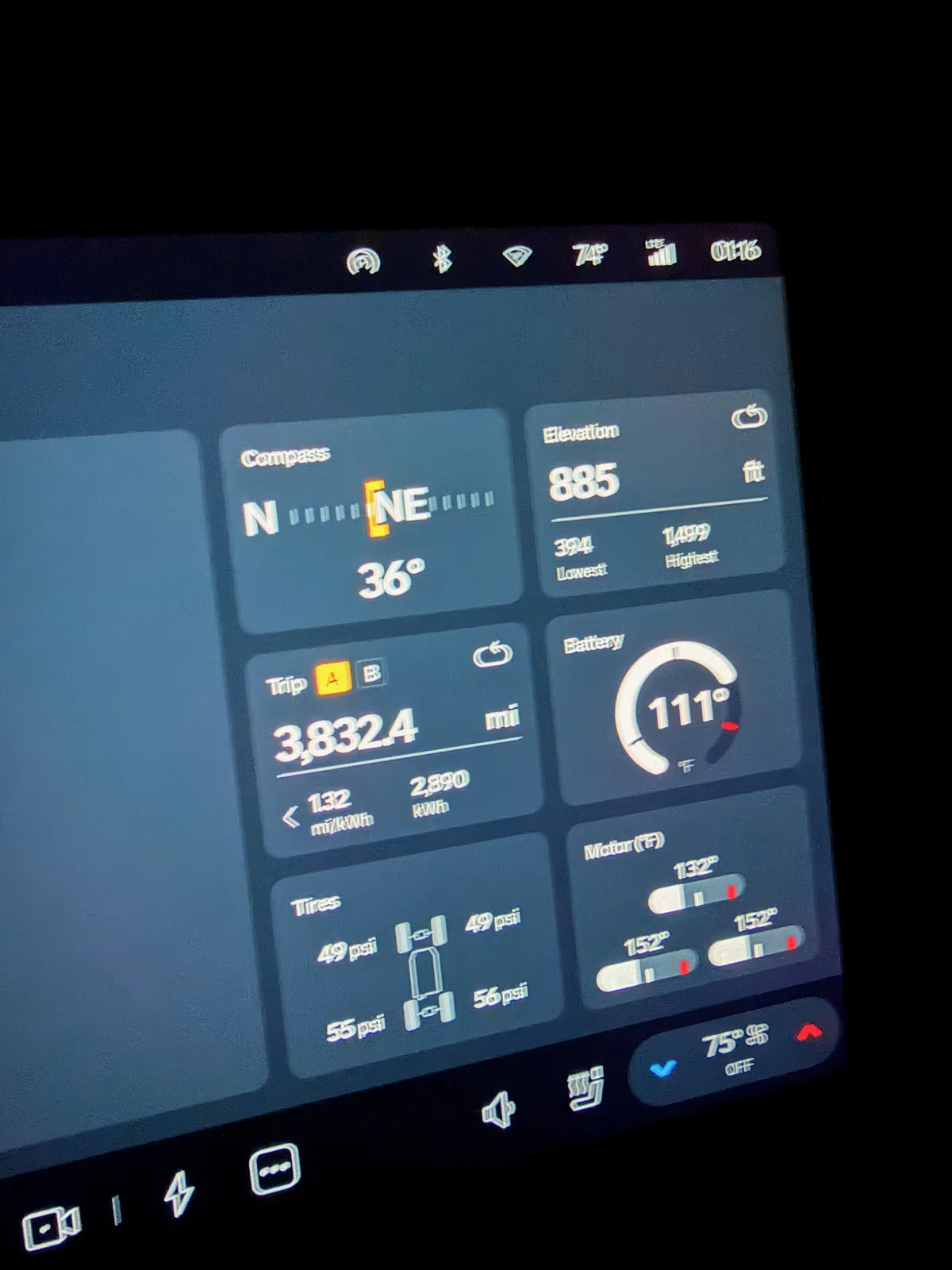 The Rivian R1T center display at the Independence MO charger at 1:16 AM showing Trip A 3,832.4 miles, 1.32 mi/kWh, 2,890 kWh cumulative, elevation 885 feet, compass NNE