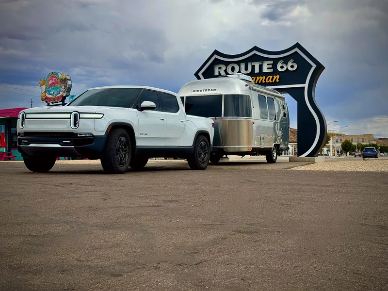 The 20-foot Airstream Caravel hitched to the white Rivian R1T at sunset near Kingman, Arizona