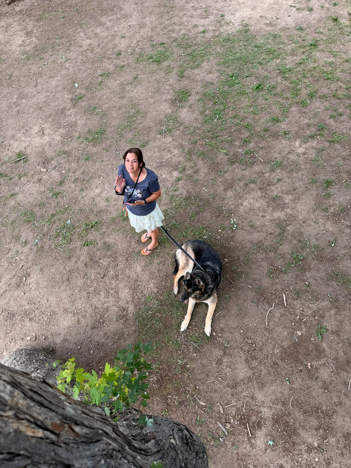 Mission the German shepherd and a hiker out on the red rock above the St. Vrain at the Lyons campground