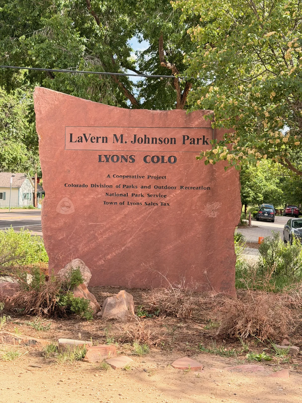 The red sandstone entrance sign for LaVern M. Johnson Park in Lyons, Colorado, the town-run riverside campground that was our Rocky Mountain National Park basecamp