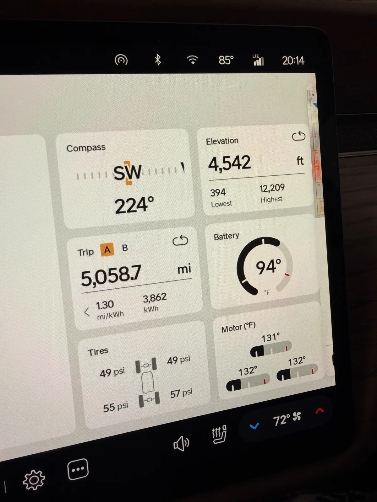 Rivian R1T center display at the Grand Junction RAN at 8:14 PM showing Trip A 5,058.7 miles at 1.30 mi/kWh and 3,862 kWh trip-to-date, elevation 4,542 ft, battery 94 F