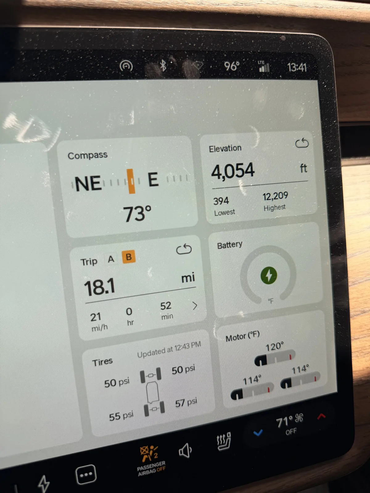 Rivian R1T center display at Sun Outdoors Moab at 1:41 PM showing Trip B 18.1 miles at a 21 mph average over 52 minutes, elevation 4,054 ft, battery charging, motor temps 114 to 120 F