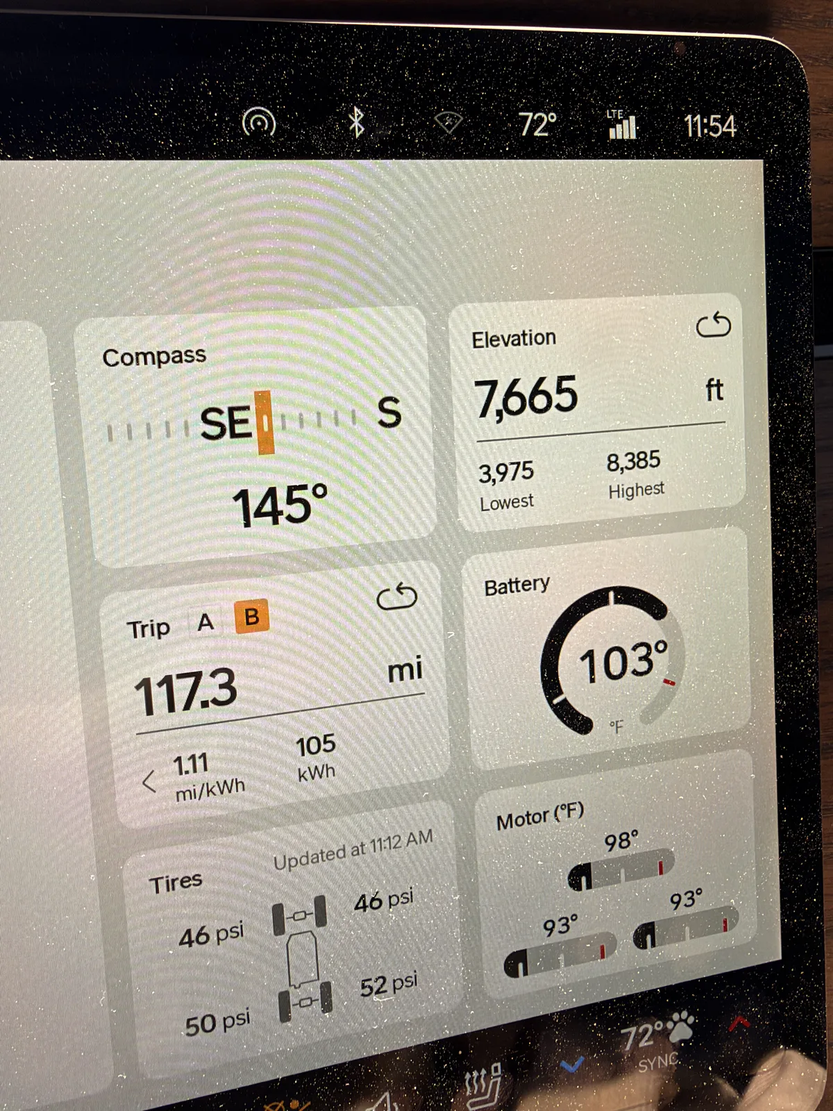 Rivian R1T center display showing un-reset Trip B 117.3 miles at 1.11 mi/kWh and 105 kWh, elevation 7,665 ft, ambient 72 F