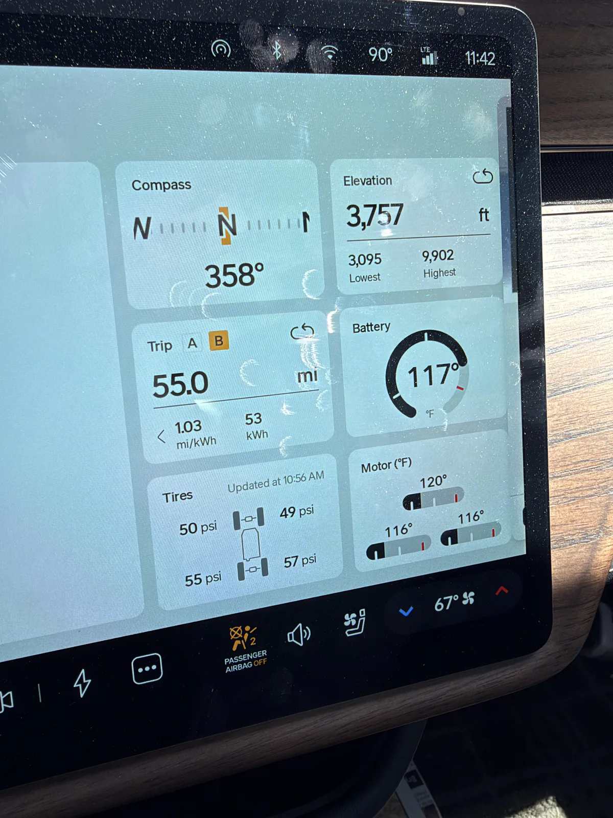 Rivian R1T center display showing un-reset Trip B 55.0 miles at 1.03 mi/kWh and 53 kWh, elevation 3,757 ft, tires 49 to 57 psi