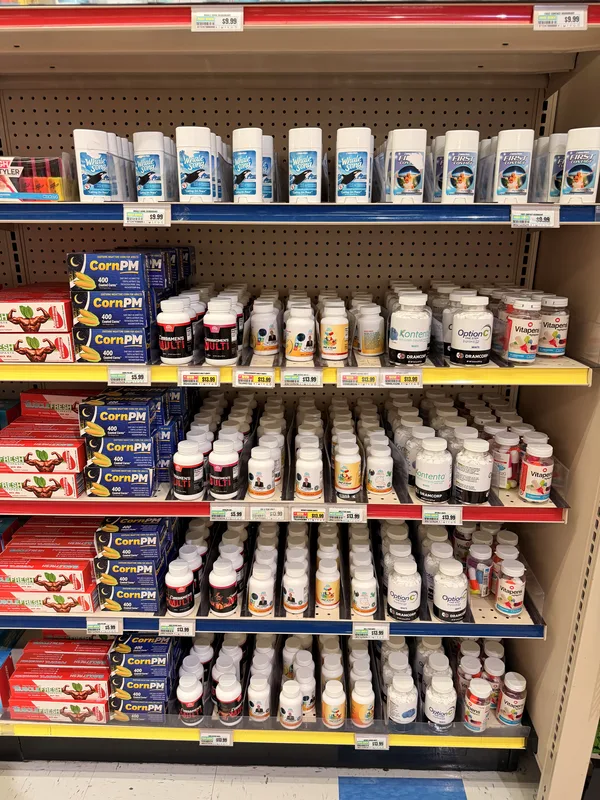 Shelves of parody products including CornPM boxes stocked like a real supermarket inside Omega Mart