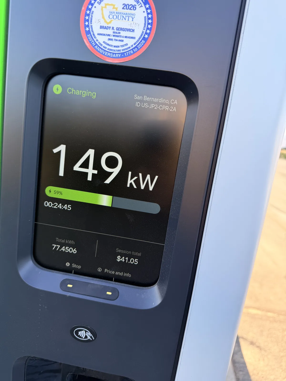 Rivian Adventure Network pedestal screen in San Bernardino, California showing the R1T charging at 149 kW, 59 percent, 77.45 kWh delivered and a $41.05 session total
