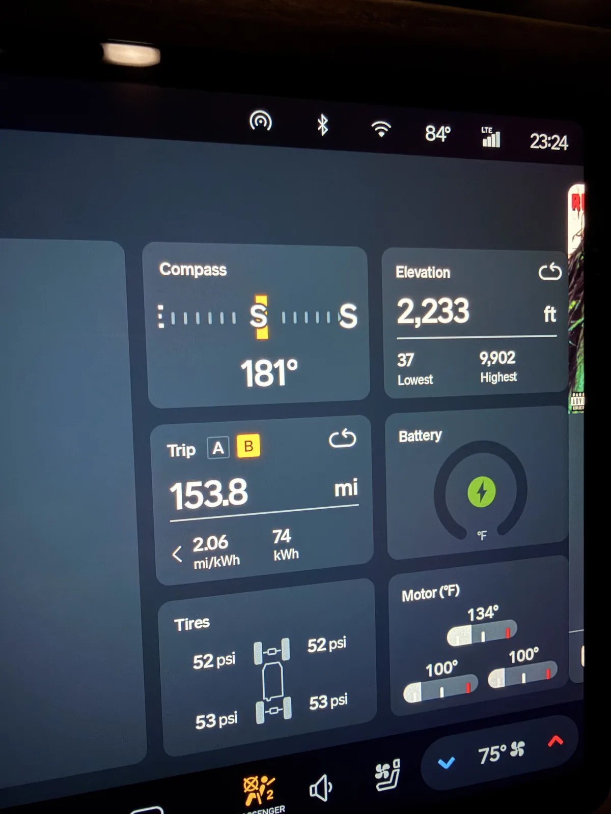 The Rivian R1T center display in Las Vegas showing Trip B 153.8 miles at 2.06 mi/kWh and 74 kWh for the Barstow to Las Vegas leg, elevation 2,233 ft, ambient 84°F.