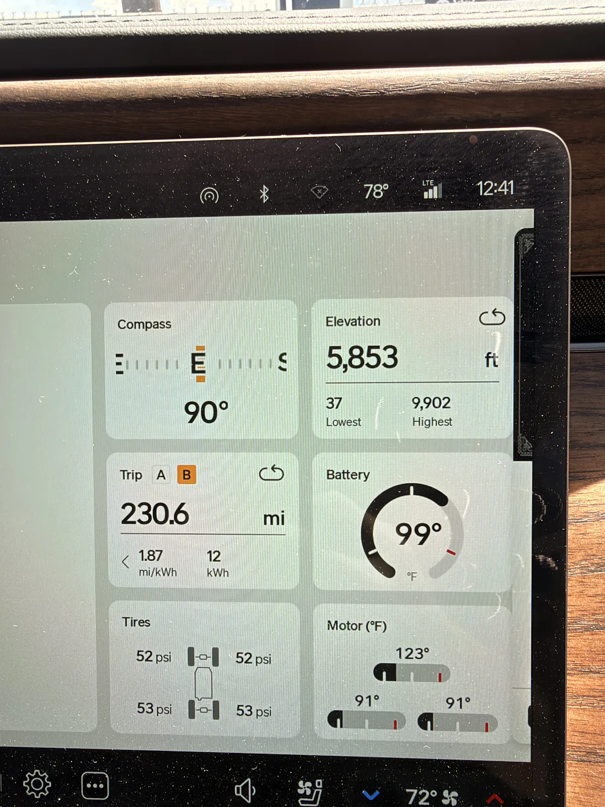 The Rivian R1T center display in Beaver, Utah showing Trip B 230.6 miles at 1.87 mi/kWh for the Las Vegas to Beaver leg, elevation 5,853 ft.