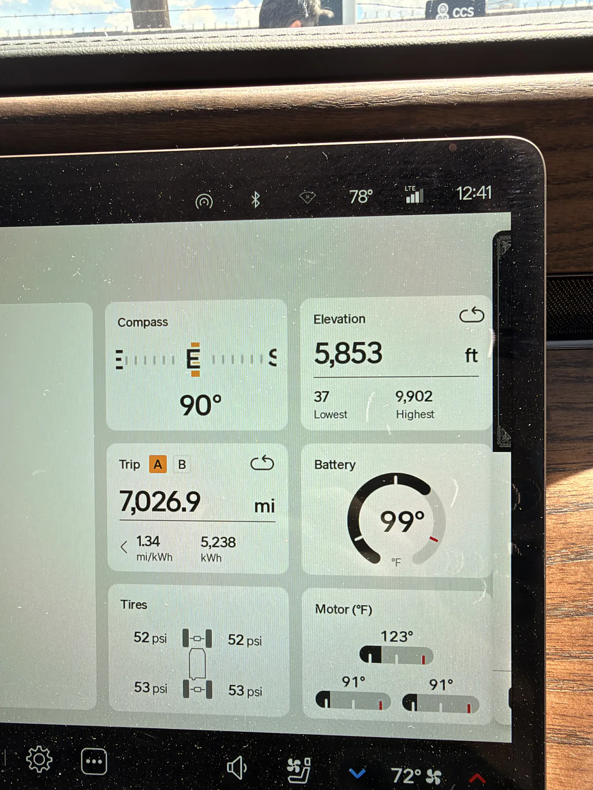 The Rivian R1T center display in Beaver, Utah showing Trip A 7,026.9 miles at 1.34 mi/kWh and 5,238 kWh cumulative, elevation 5,853 ft, motor temps 91 to 123°F, tires 52 to 53 psi.
