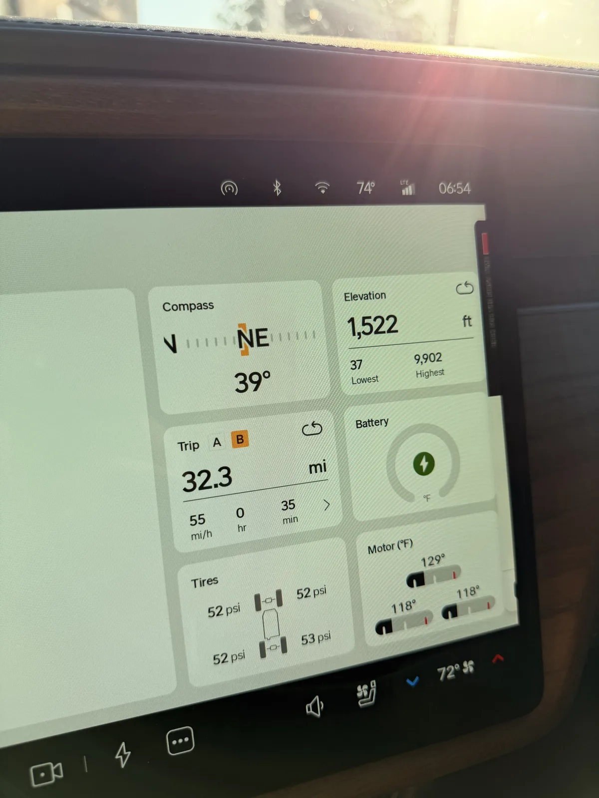 The Rivian R1T instrument display at the Moapa, Nevada Supercharger showing Trip B 32.3 miles at a 55 mph average, elevation 1,522 ft, battery charging, motors 118 to 129°F, towing.