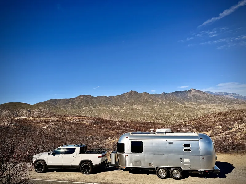 The 23-foot Airstream International hitched to the Rivian R1T in the mountains at Ribbonwood, California