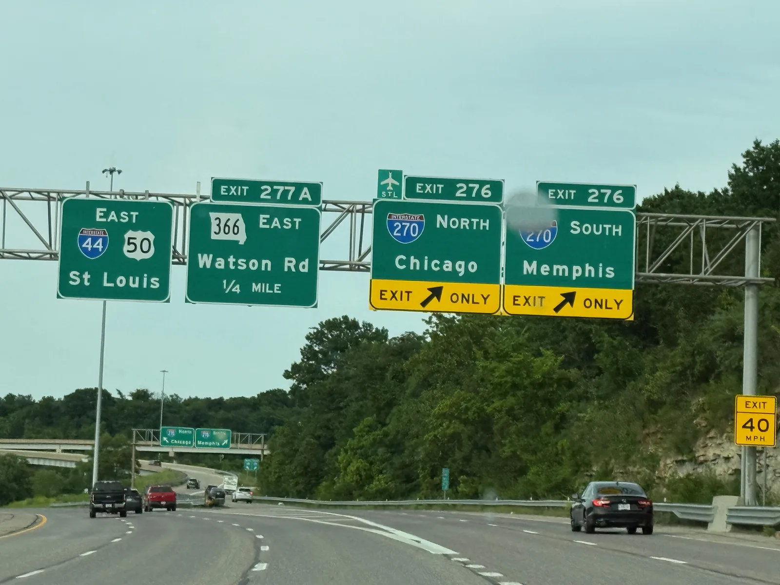An overhead highway sign on I-44 East approaching St. Louis, green panels for I-55 North to Chicago and I-55 South to Memphis with exit-only lanes