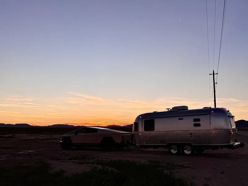 A Tesla Cybertruck parked next to the 23-foot Airstream International in the Arizona desert.
