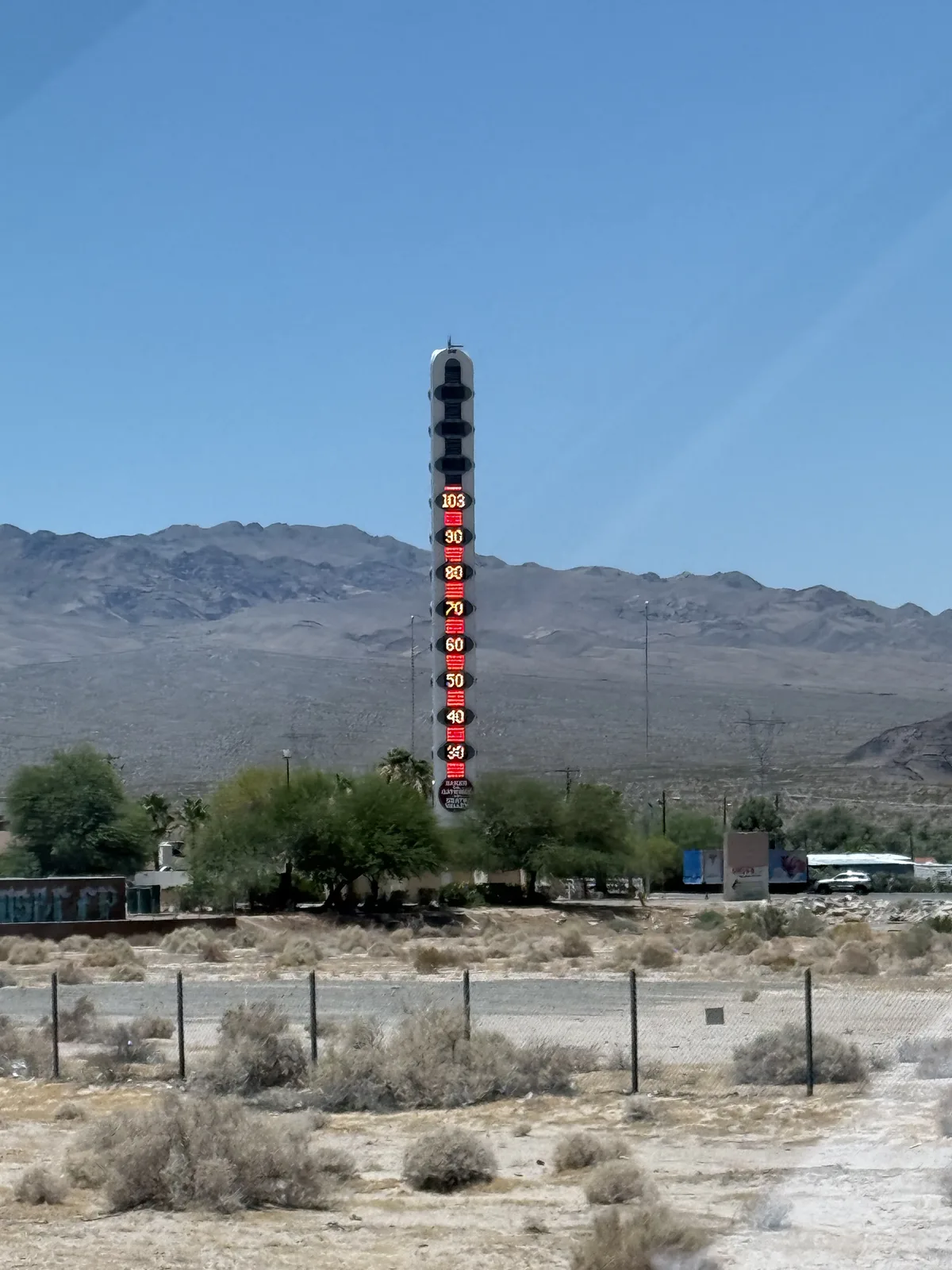 The 134-foot World's Tallest Thermometer rising over desert scrub and bare mountains at Baker, California, in the Mojave Desert