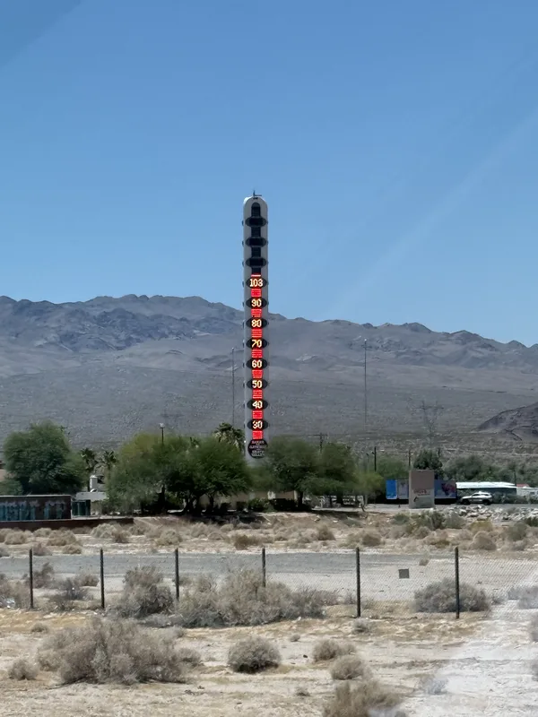 The 134-foot World's Tallest Thermometer rising over desert scrub and bare mountains at Baker, California, in the Mojave Desert