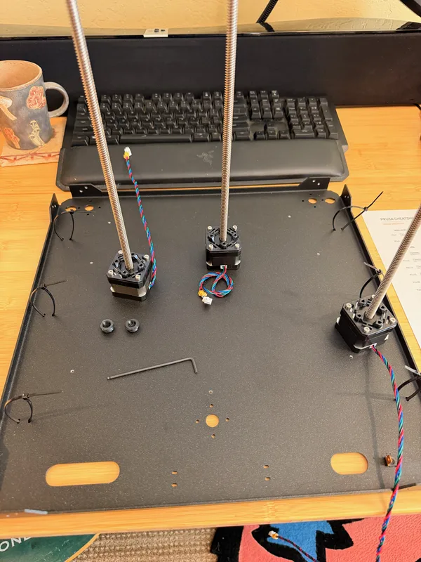The Prusa CORE One frame partially assembled on the build mat