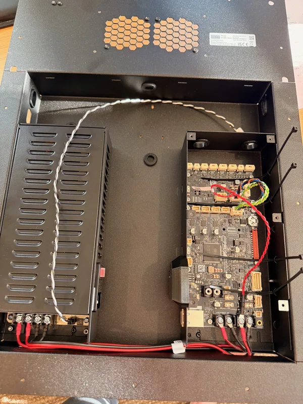 The 3D printer electronics bay open, with wiring and cable routing visible