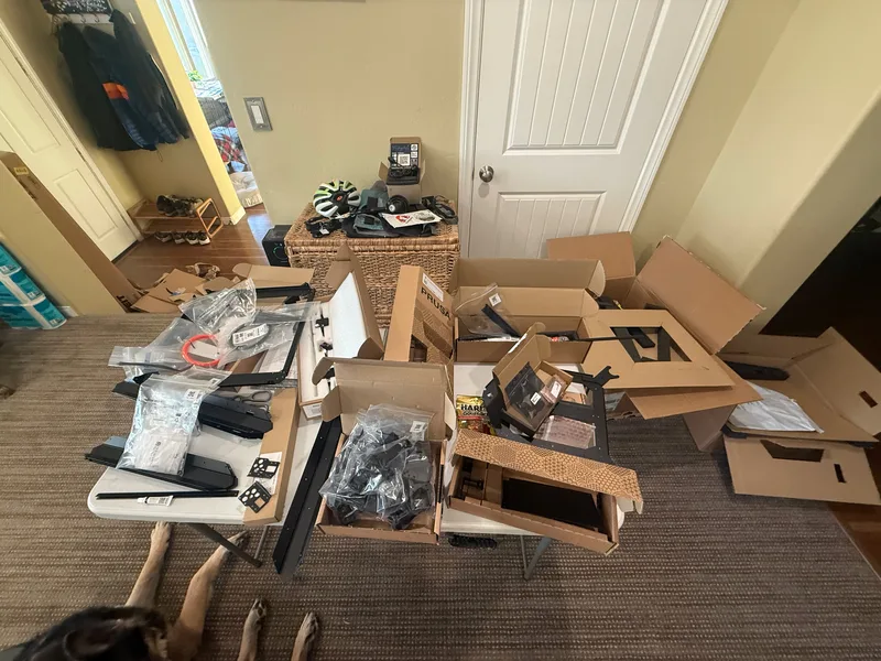 The workspace surrounded by cardboard and packaging as the assembly wraps up
